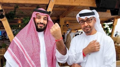 Sheikh Mohamed bin Zayed and Saudi Arabia's Crown Prince Mohammed bin Salman wear the Special Olympics wrist band during the Formula E race in Riyadh. Courtesy Special Olympics World Games Abu Dhabi Twitter