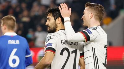 Germany midfielder Ilkay Gundogan celebrates scoring the opening goal from the penalty spot with his teammate Marco Reus. AFP