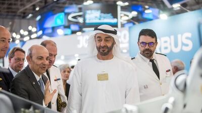 Sheikh Mohammed bin Zayed - once a pilot in the UAE Air Force - visits a manufacturer's stand. Leslie Pableo for The National