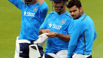 MS Dhoni, centre, feels Ravindra Jadeja, left, is talented and can be handy when he starts ‘being himself’ on the field. Rui Vieira / AP Photo