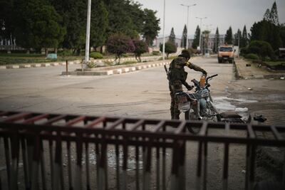 A Syrian fighter uses a plastic bottle to fuel his motorcycle near Latakia. AP