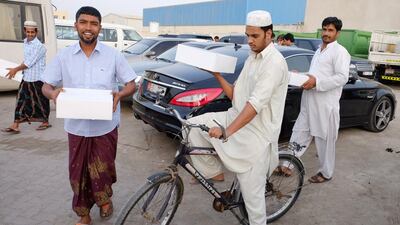 Workers were thrilled to receive a surprise iftar box from the volunteer group Giveback UAE on Sunday. Delores Johnson / The National