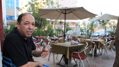 A shisha shop owner waits for customers in the neighbourhood.