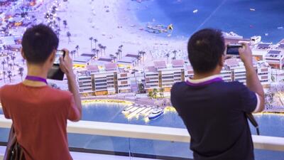 Visitors take photos of the La Mer development by Meraas Holding. Antonie Robertson / The National