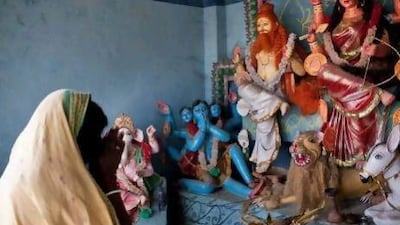 A villager prays to the goddess Durga, who is always depicted riding a tiger, in the Bono Devi temple on Gosaba island. A tiger hid in this temple after attacking a woman.