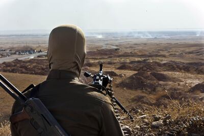 A member of the Kurdish Peshmerga forces overlooking ISIL positions in Jalawla in Diyala province in 2014. AFP