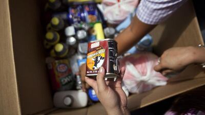 Many Filipinos send Balikbayan boxes, a sort of care package containing personal items such as food, toiletries and clothing, to families at home. Andrew Henderson / The National