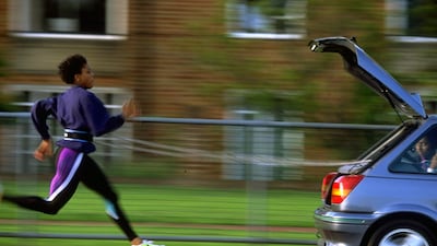 British athlete Marcia Richardson chases after a Ford Fiesta during a training run in Windsor, in 1993. Getty Images
