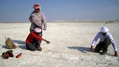 Abdulla Al Kaabi (left), Abdul Rahman Al Nuaimi and co-author Mark Beech (standing) acquire field measurements at Mleisa 1.