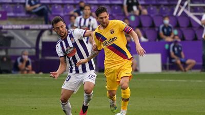 Real Valladolid's Spanish midfielder Oscar Plano battles with Lionel Messi. AFP