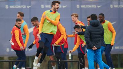 Gerard Pique, centre, during Barcelona's training session at Joan Gamper sports city. EPA