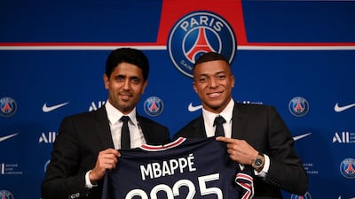 Paris Saint-Germain cheif executive Nasser Al Khelaifi with Kylian Mbappe after the French attacker signed a new contract with the club in 2022. AFP
