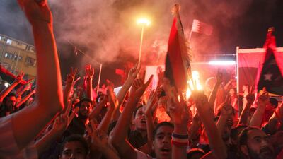 People celebrate the capture in Tripoli of Moammar Gadhafi's son and one-time heir apparent, Seif al-Islam, at the rebel-held town of Benghazi, Libya, early Monday, Aug. 22, 2011. Libyan rebels raced into Tripoli in a lightning advance Sunday that met little resistance as Moammar Gadhafi's defenders melted away and his 40-year rule appeared to rapidly crumble. The euphoric fighters celebrated with residents of the capital in the city's main square, the symbolic heart of the regime. (AP Photo/Alexandre Meneghini) *** Local Caption *** Mideast Libya.JPEG-0c633.jpg