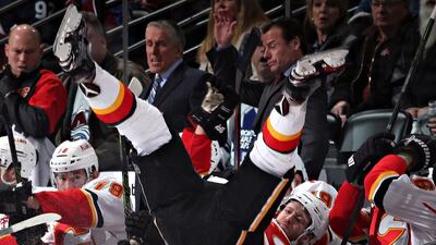 Dougie Hamilton #27 of the Calgary Flames is checked into his bench by Erik Johnson #6 of the Colorado Avalanche. Doug Pensinger / Getty Images / AFP