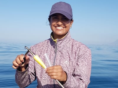 Dr Dominique Paynee, a scientist in South Africa who researches Bryde's whales, with an arrow used to collect a sample of blubber from the whales so that genetic analysis can take place. Photo: Dr Paynee