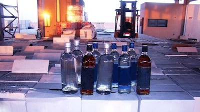 Al Ghuwaifat customs officials seize a box of 30,708 bottles of alcohol. Courtesy Abu Dhabi Customs