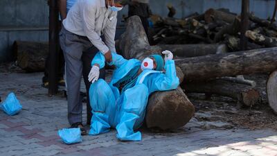 A relative of a person who died of Covid-19 breaks down during cremation in Jammu. AP