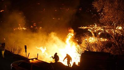 Local emergency officials warned of powerful winds that will feed wildfires raging in Los Angeles, threatening multi-million dollar mansions. Sandy Huffaker / AFP Photo