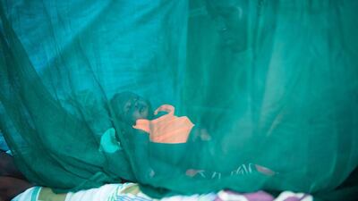A young mother holds her child in her IDP (Internaly Displaced Persons) shelter in the UNMISS camp in Juba. According to UNMISS spokesperson Ariane Quinter, the UNMISS will be closing the IDP site and relocating them to a new site in Jebel Area due to the congestion at the current site in Tomping. Charles Lomodong / AFP