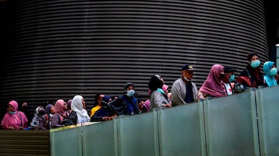 Visitors wearing protective face masks visit the tsunami museum in Banda Aceh on March 11, 2020. AFP