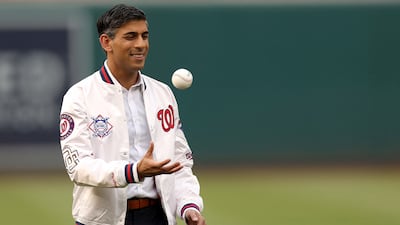 Rishi Sunak tosses a baseball in the air after being introduced before the start of the Washington Nationals and Arizona Diamondbacks game. AFP