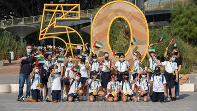 Young visitors pose in front of one of the installations at Expo 2020 in celebration of the UAE's Golden Jubilee. Image: Expo 2020 Dubai