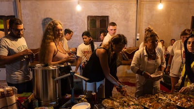 Visitors to the event enjoy the snacks on offer at the event hosted by Dubai Astronomy Group. Antonie Robertson/The National