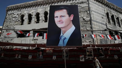 A man walks past a banner depicting Syrian President Bashar Al Assad in Douma, outside Damascus, Syria, September 17, 2018. Reuters