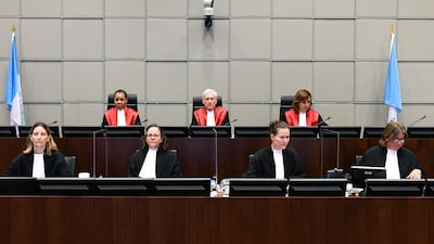 Presiding Judge, Judge David Re, top centre, with Judge Janet Nosworthy, left, and Judge Micheline Braidy, during a session of the United Nations-backed Lebanon Tribunal in Leidschendam, Netherlands Tuesday Aug. 18, 2020, where it is scheduled to hand down it's judgement in the case against four men being tried for the bombing that killed former Lebanon Prime Minister Rafik Hariri and 21 others. The U.N.-backed tribunal in the Netherlands is to deliver verdicts in the trial held in absentia of four members of the militant Lebanese Hezbollah group accused of involvement in the 2005 truck bomb assassination of former Lebanese Prime Minister Rafik Hariri. (Piroschka Van De Wouw/Pool via AP)