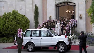 Prince Hussein and Princess Rajwa leave after the wedding ceremony. Reuters