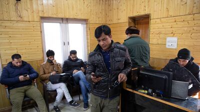 Kashmiri journalists browse the internet on their mobile phones inside the media centre set up by government authorities in Srinagar, Indian controlled Kashmir. AP, File