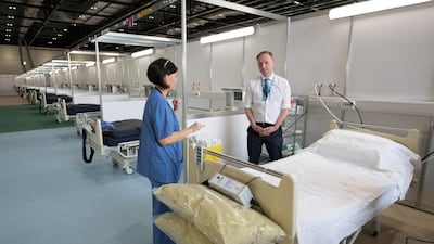 NHS England's Chief Executive Simon Stevens speaks with NHS staff at ExCel London, during its conversion into the temporary NHS Nightingale Hospital, comprising of two wards, each of 2,000 people, to help tackle the coronavirus outbreak, in Newham, London. REUTERS