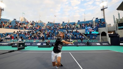 Stefanos Tsitsipas hits a ball into the crowd after his opening day win. Chris Whiteoak / The National