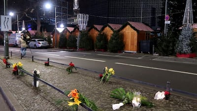 Candles and flowers are seen near the site where a lorry ploughed through a crowd at a Berlin Christmas market on Breitscheidplatz square near the fashionable Kurfuerstendamm avenue. Fabrizio Bensch / Reuters