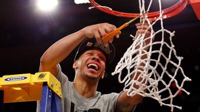Shabazz Napier of the Connecticut Huskies cuts down the net after defeating the Michigan State Spartans to win the East Regional Final of the 2014 NCAA Men's Basketball Tournament at Madison Square Garden on Sunday in New York City. Elsa / Getty Images / AFP ?/ March 30, 2014