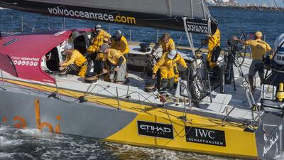 Crew members work aboard the yacht Azzam as Abu Dhabi Ocean Racing complete the first leg of the Volvo Ocean Race on Wednesday, coming first into South Africa among the seven-boat fleet. Rodger Bosch / AFP