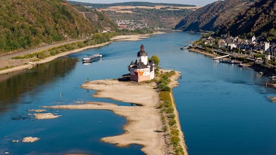 Drone shows the "Burg Pfalzgrafenstein" (Pfalzgrafenstein Castle) on an island in the dried-up river Rhine in Kaub, western Germany. As a heat wave dries Germany's rivers, government ministers are at odds over what to do about it -- re-engineer the waterways or restore them to their natural state. The debate has flared as precariously falling water levels have revealed vast sandbanks on the Rhine, Danube, Elbe and other rivers, severely impacting cargo shipping crucial for many industries. With climate change driving new heat records and longer dry spells in Europe and beyond, scientists warn that the problem will intensify in coming years. AFP