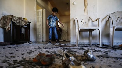 A Palestinian boy enters his family's damaged apartment in Rafah in the southern Gaza strip. AFP
