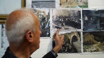 Joseph Elias Yalda, director of the Heritage Museum of Al Qosh, points to old photographs of the Prophet Nahum synagogue.