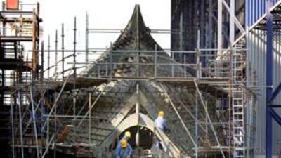 Workers work on the bow of a military ship at ADSB, Abu Dhabi, on Dec 14 2008.