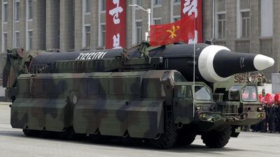 An unidentified missile that analysts believe could be the North Korean Hwasong-12 is paraded across Kim Il-sung Square in Pyongyang. Wong Maye-E / AP Photo