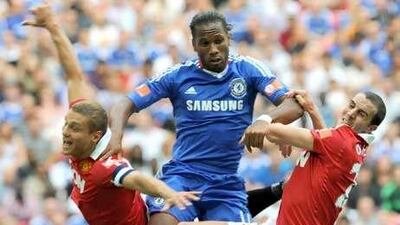 Didier Drogba, centre, muscles past Manchester United's Nemanja Vidic, left, and John O'Shea.