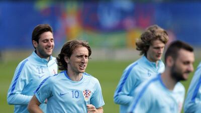 Croatia midfielder Luka Modric (2nd L) and teammates jog during a training session in Deauville on June 23, 2016, during the Euro 2016 football tournament. Charly Triballeau / AFP