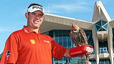 Lee Westwood poses with a falcon on his arm in front of the clubhouse during a photocall.