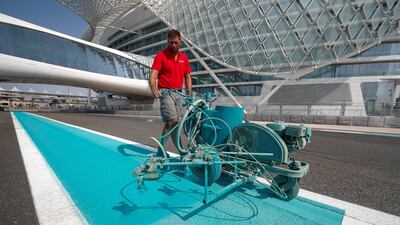 A worker applying paint to Yas Marina Circuit. Courtesy Seven Media