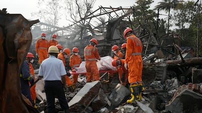 Rescuers carry the body of a person killed in an explosion and fire at a chemical factory in Dombivali, near Mumbai. AP
