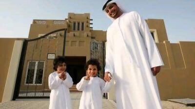 Abdullah Al Jeaid, pictured with his sons, collected his villa keys yesterday.