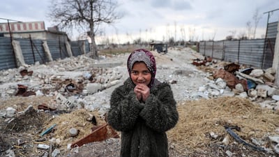 A Syrian girl Shaimaa stands among the rubble next to her shelter in Al Ashaari, Eastern Al Ghouta, Syria, in January. EPA