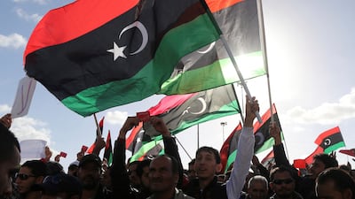 People wave Libyan flags during a demonstration in Benghazi, in 2014. Reuters