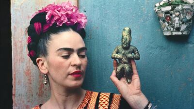 Frida Kahlo with Olmec figurine, 1939, photograph by Nickolas Muray © Nickolas Muray Photo Archives